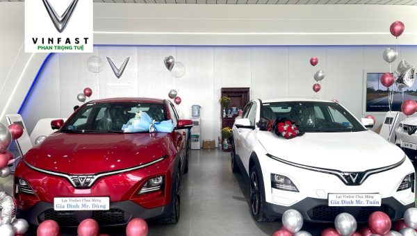 Hai xe VinFast màu đỏ và trắng được trang trí hoa, bóng bay tại showroom Phan Trọng Tuệ Đà Nẵng